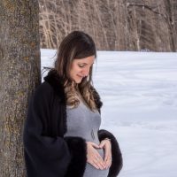 pregnant woman holding her belly and gazing down